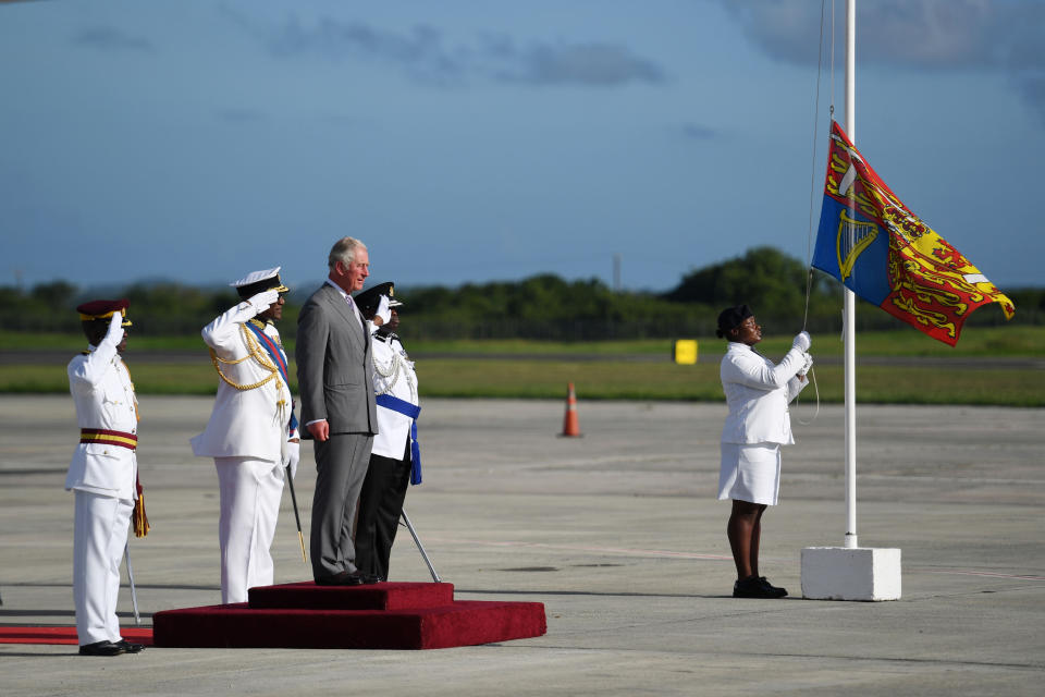 The Prince of Wales views a guard of honour as he arrives at V.C Bird International Airport in Antigua.