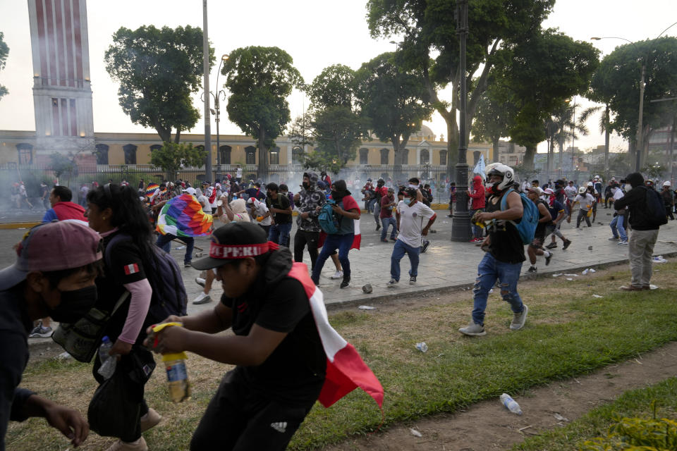 Anti-government protesters face off against the police in Lima, Peru, Thursday, Jan. 19, 2023. Protesters are seeking immediate elections, the resignation of President Dina Boluarte, the release from prison of ousted President Pedro Castillo and justice for protesters killed in clashes with police. (AP Photo/Martin Mejia)