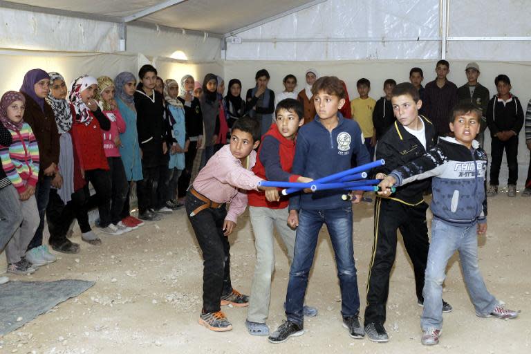 Syrain refugee children perform King Lear, one of Shakespeare's great tragedies, at the sprawling Zaatari refugee camp in Jordanian desert near the border with Syria, on March 8, 2014