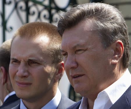 Then-Ukrainian President Viktor Yanukovich (R) is pictured with his son Oleksandr in this April 2010 file photo. REUTERS/Stringer/Files