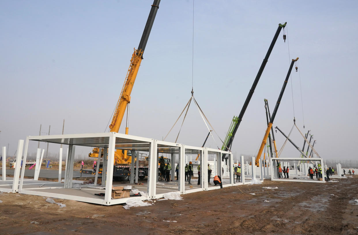 In this photo released by China's Xinhua News Agency, workers build a large centralized quarantine facility in Shijiazhuang in northern China's Hebei Province, Thursday, Jan. 14, 2021. A city in northern China is building a 3,000-unit quarantine facility to deal with an anticipated overflow of patients as COVID-19 cases rise ahead of the Lunar New Year travel rush. (Yang Shiyao/Xinhua via AP)