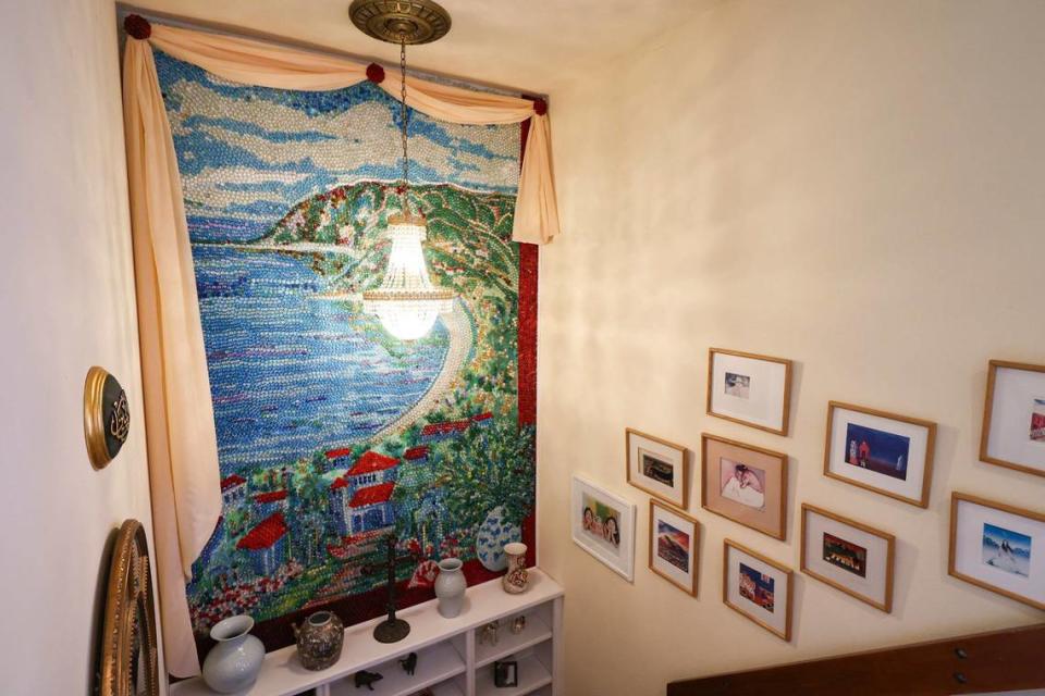 A mosaic of a coastal scene fills the stairway in the San Luis Obispo home owned by Bruce and Suki Mason, seen here on May 10, 2024. The work was originally painted by artist Gini Griffin in 1992 for the previous owners of the house, Jon and Kathy Eichler, who commissioned her to create a mural evoking a seaside town in South America, Griffin told The Tribune. Some 26 years later, Mason turned it into a mosaic. 