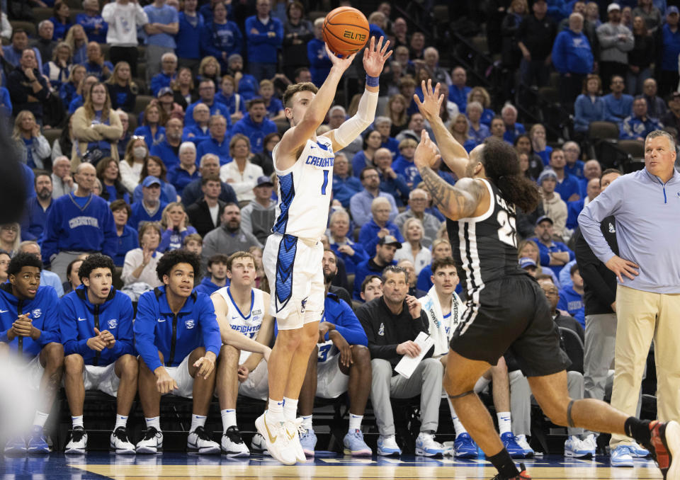 Creighton's Steven Ashworth (1) shoots a three pointer against Providence's Devin Carter (22) with 56 seconds remaining in the second half of an NCAA college basketball game Saturday, Jan. 6, 2024, in Omaha, Neb. Creighton defeated Providence 69-60. (AP Photo/Rebecca S. Gratz)