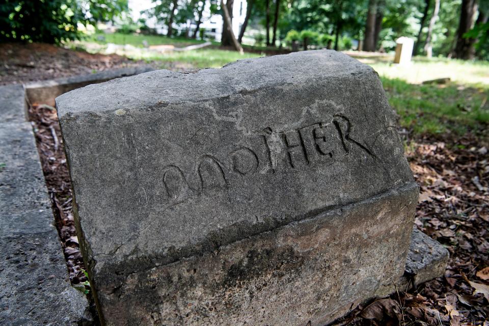 A headstone with hand carved letters at the South Asheville Cemetery July 5, 2023.