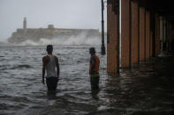 <p>Cubans stand in a flooded street in Havana, on Sept. 10, 2017. (Photo: Yamil Lage/AFP/Getty Images) </p>