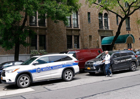 Medical examiner vehicles park outside the front entrance to the Park Avenue apartment of designer Kate Spade in New York, U.S. June 5, 2018. REUTERS/Brendan McDermid