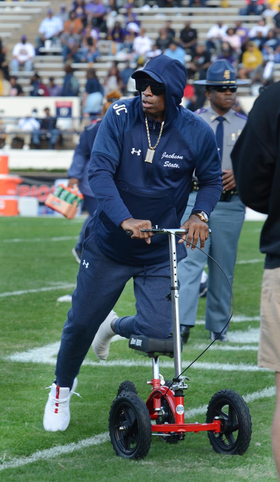 Jackson State coach Deion Sanders makes his way around the field as the Tigers warm up before the SWAC Championship against Prairie View A&M at Veteran's Memorial Stadium in Jackson, Miss., on Dec. 4, 2021.