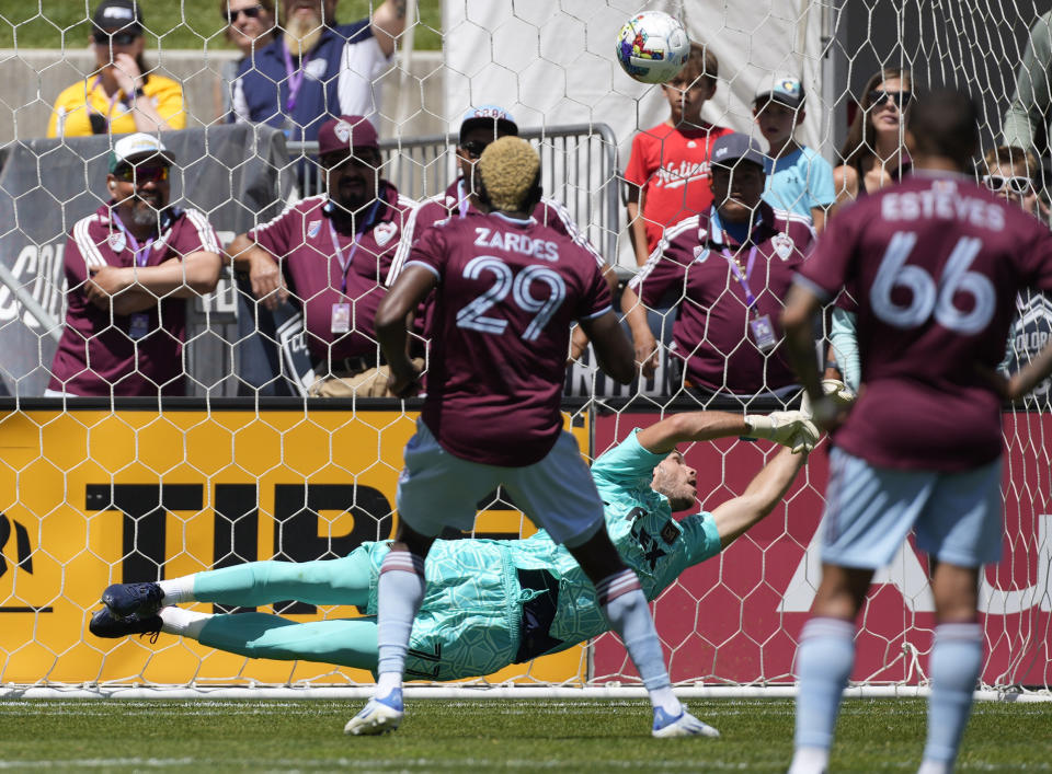 Los Angeles FC goalkeeper John McCarthy, back, misses a penalty shot off the foot of Colorado Rapids attacker Gyasi Zardes (29) for a goal in the first half of an MLS soccer match Saturday, May 14, 2022, in Commerce City, Colo. (AP Photo/David Zalubowski)