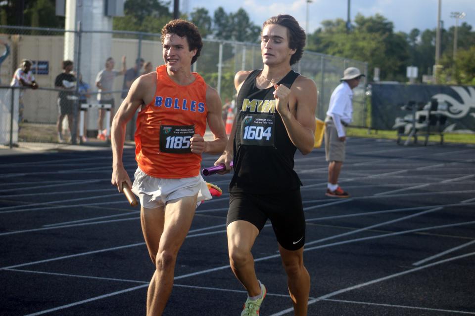 Bolles' Miles Rivera (1185) and Montverde's Colton Cardwell (1604) race in the boys 4x800-meter relay. Bolles won the event on the way to the boys team championship.