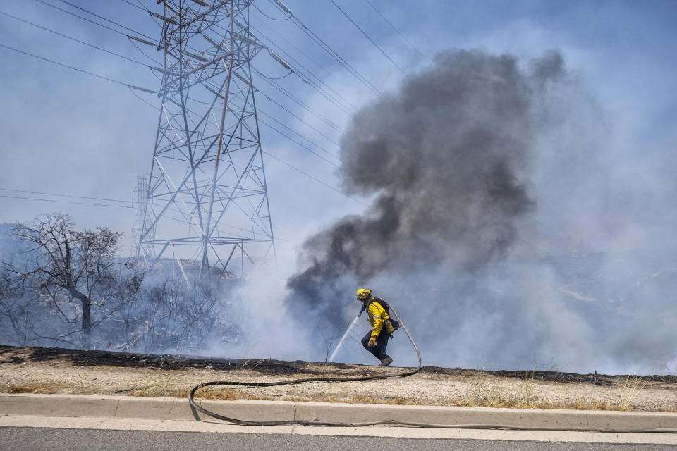 Los Angeles County firefighters work to extinguish a brushfire along the Sierra Highway on July 15.