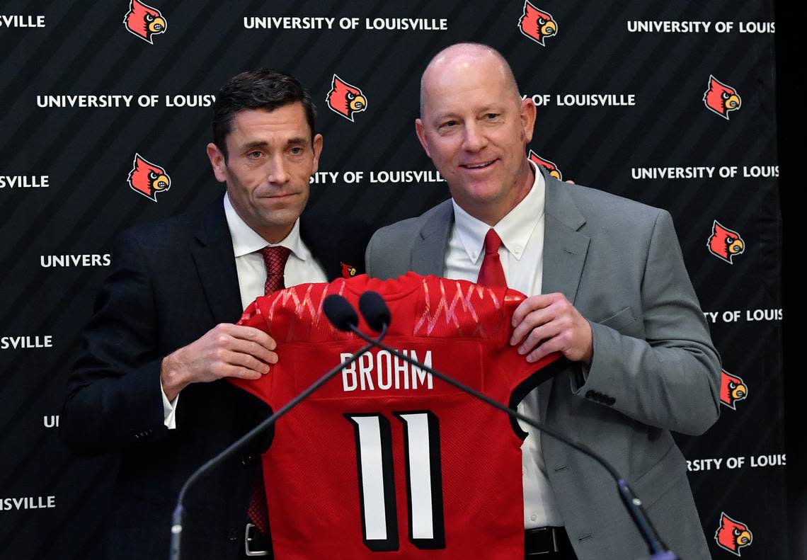 Louisville Athletic Director Josh Heard, left, presented new Cardinals football coach Jeff Brohm with a U of L jersey bearing the same number Brohm wore as a quarterback for the Cards. Brohm has subsequently remade the Louisville roster, bringing in at least 20 incoming transfers. Timothy D. Easley/AP