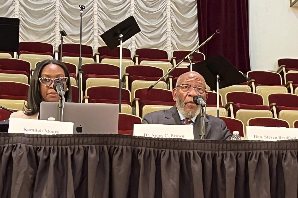 Chair Kamilah Moore, left, and vice-chair Rev. Amos C. Brown listen during a reparations task force meeting at Third Baptist Church in San Francisco, Wednesday, April 13, 2022. California's first-in-the-nation reparations task force met for the first time since its inaugural meeting nearly a year ago. The live meeting also comes mere weeks after the group voted to limit restitution to descendants of enslaved or free Black people in the U.S. before the 20th century. (AP Photo/Janie Har)