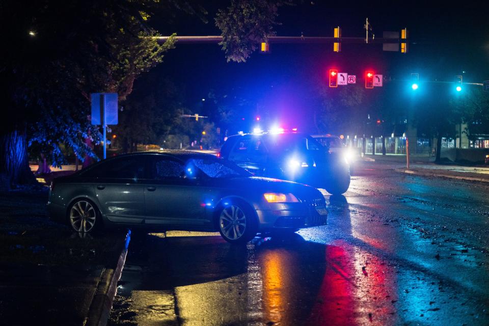 A damaged vehicle sits partially in the road at Mulberry Street and College Avenue after a heavy rainstorm in Fort Collins on Monday.