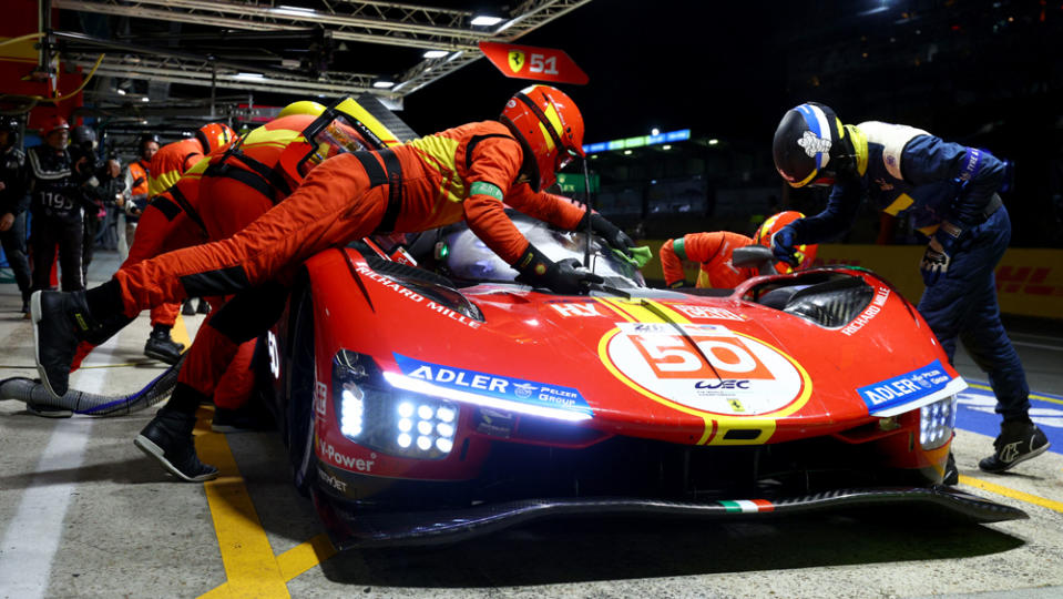 Ferrari's car No. 50, with drivers Antonio Fuoco, Miguel Molina, and Nicklas Nielsen rotating behind the wheel, makes a pit stop during the 2023 24 Hours of Le Mans.