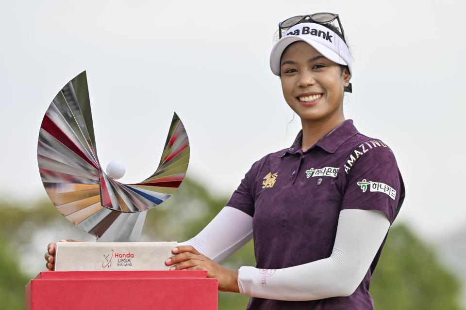 Patty Tavatanakit of Thailand poses for a photo with her trophy during the award ceremony after winning the LPGA Honda Thailand golf tournament in Pattaya, southern Thailand, Sunday, Feb. 25, 2024. (AP Photo/Kittinun Rodsupan)