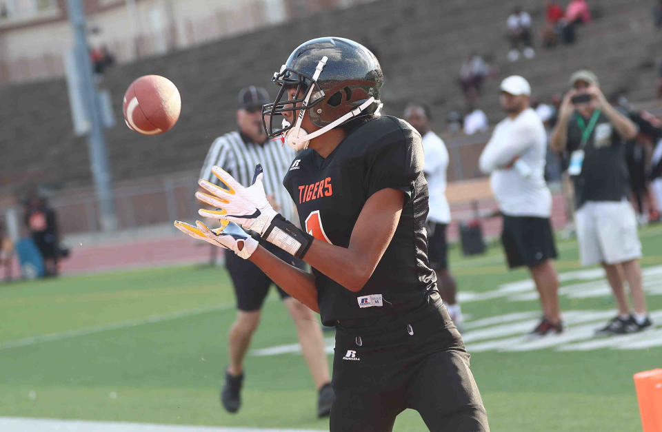 Chris Henry Jr. was a top receiver for the undefeated Withrow Junior High program. He recently transferred to the West Clermont School District with his younger brother, DeMarcus. Both live with Henry's former teammate, Adam "Pacman" Jones.