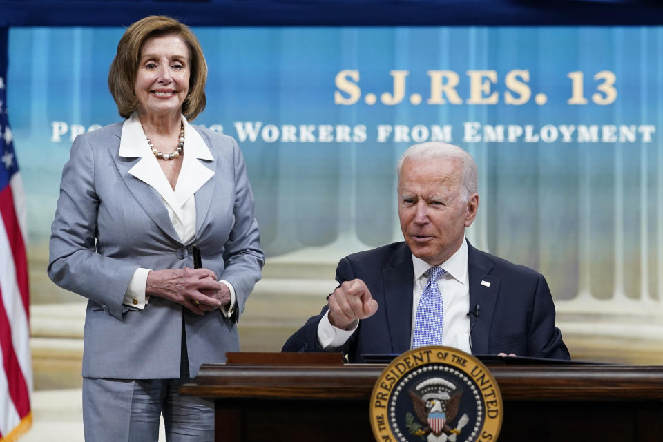 President Joe Biden, joined by House Speaker Nancy Pelosi of Calif., talks in-between signing signs several bills during an event in the South Court Auditorium on the White House complex in Washington, Wednesday, June 30, 2021. (AP Photo/Susan Walsh)