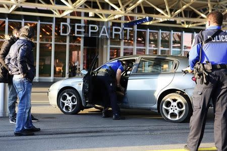 County of Geneva police officers check a car outside Cointrin airport in Geneva, Switzerland, December 10, 2015. REUTERS/Pierre Albouy