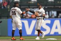 San Francisco Giants' Brandon Crawford, left, celebrates with Thairo Estrada after the Giants defeated the Milwaukee Brewers 5-1 in a baseball game in San Francisco, Thursday, Sept. 2, 2021. (AP Photo/Jeff Chiu)