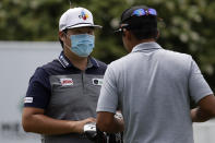 Sungjae Im. Of South Korea, wears a face masks as he chats with a fellow golfer after the second round of the World Golf Championship-FedEx St. Jude Invitational Friday, July 31, 2020, in Memphis, Tenn. (AP Photo/Mark Humphrey)