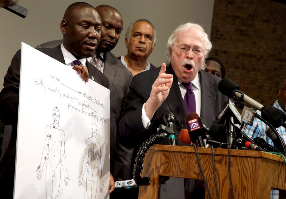 Dr. Michael Baden, right, speaks as Brown family attorney Benjamin Crump, left, holds a diagram produced during a second autopsy done on 18-year-old Michael Brown on Aug. 18, 2014, in St. Louis County, Mo. The independent autopsy shows Brown was shot at least six times.