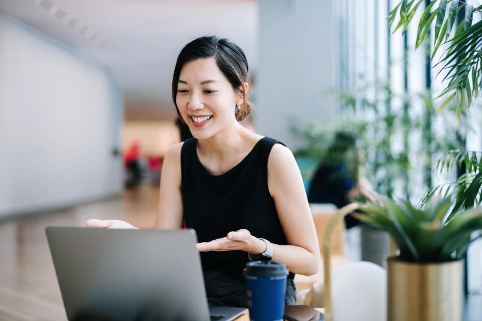 Woman talks on her computer