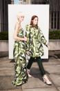 <p>Models showcasing de la Renta’s white and green banana leaf print — one in a jacquard strapless empire waist gown and the other in a quilted coat with dark pants. (Photo: Courtesy of Oscar de la Renta) </p>