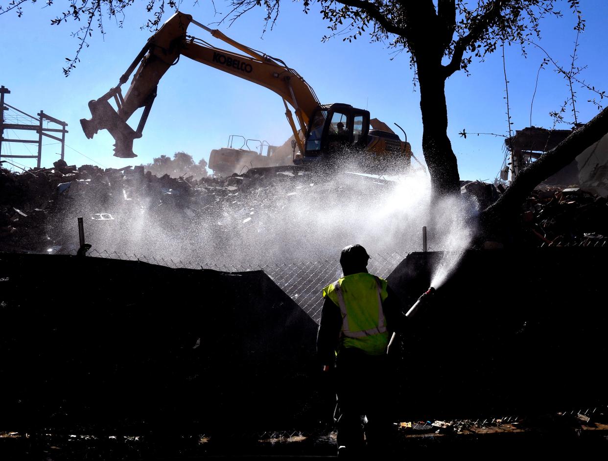 A worker sprays the rubble that was the Abilene Reporter-News building Nov. 22, 2022. The demolition of the site has taken nearly two months.
