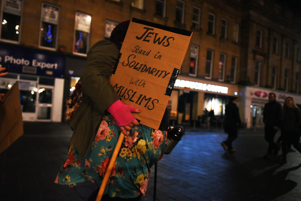 A young woman carries a sign of protest as she joins hundreds of people gathering together around Grey's Monument to protest against President Donald Trump and his policies, on January 30, 2017 in Newcastle, England. President Trump signed an executive order on Friday banning immigration to the USA from seven Muslim countries. This led to protests across America and the UK.&nbsp;