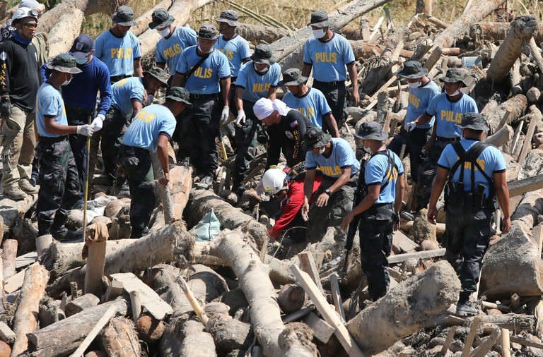 Philippine National Police help in the search for typhoon victims in New Bataan, Compostela Valley. The United Nations launched an $65 million global aid appeal Monday for the victims of the typhoon, the deadliest natural disaster in the Philippines since Tropical Storm Washi killed 1,200 people on Mindanao's north coast last year