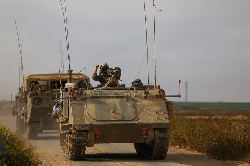 Israeli military personnel drive near the Israel-Gaza border