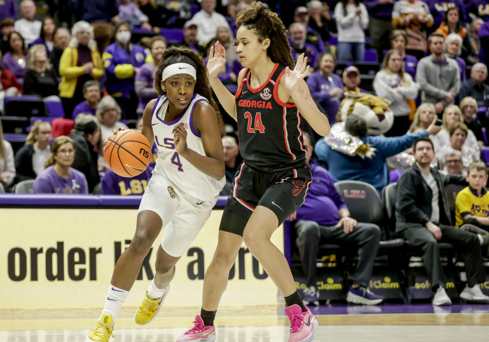 LSU guard Flau'jae Johnson (4) drives past Georgia forward Brittney Smith (24) in the first half of an NCAA college basketball game in Baton Rouge, La., Thursday, Feb. 2, 2023. (AP Photo/Derick Hingle)