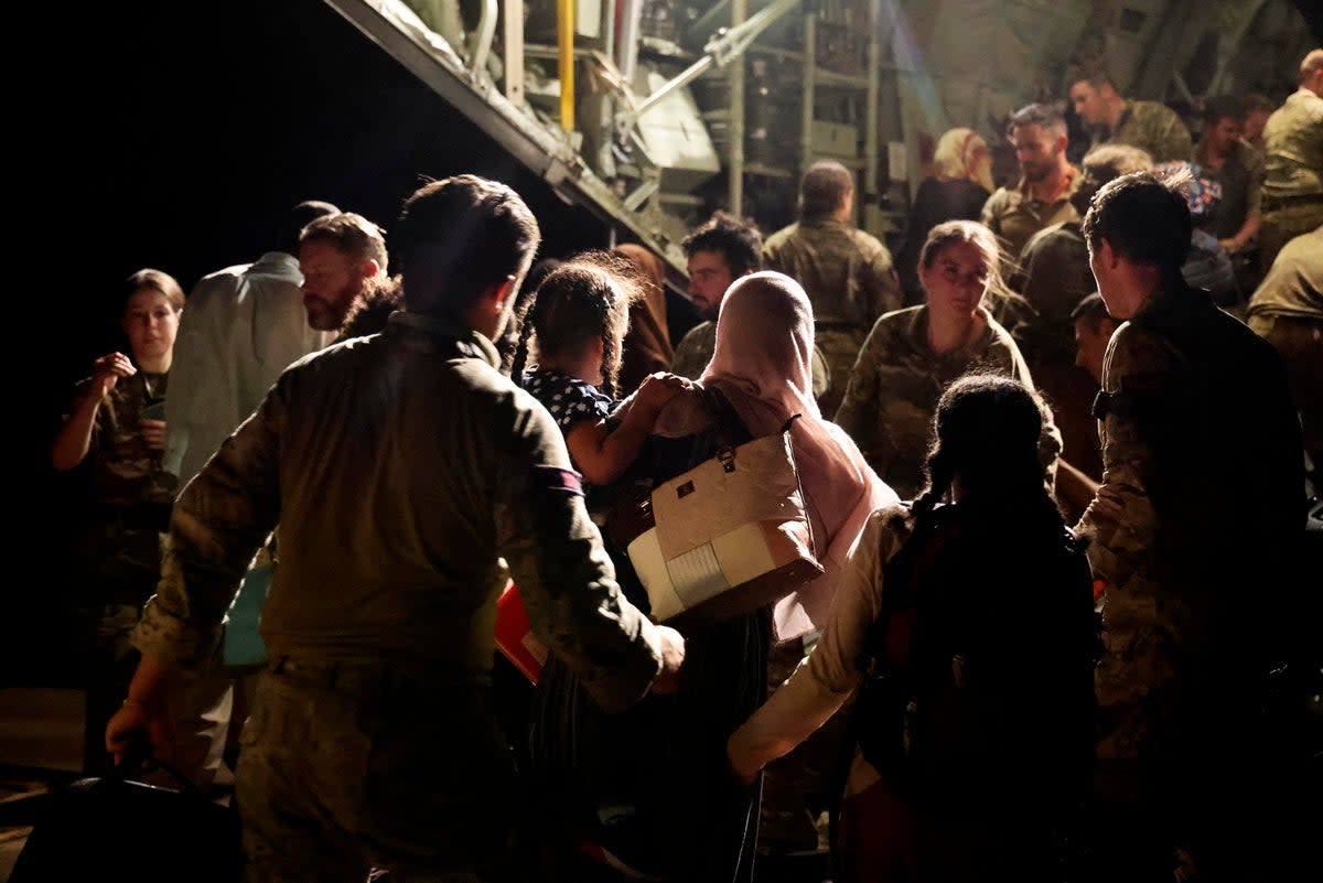 Evacuees and military personnel at Wadi Seidna airport boarding an RAF aircraft bound for Cyprus (PA)