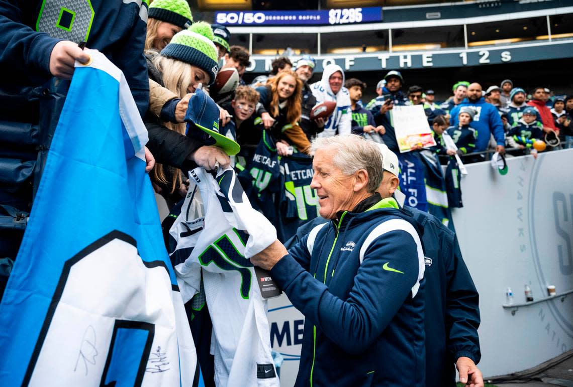 Seattle Seahawks head coach Pete Carroll signs a fan’s jersey before the start of an NFL game against the New York Jets at Lumen Field in Seattle, Wash. on Jan. 1, 2023.