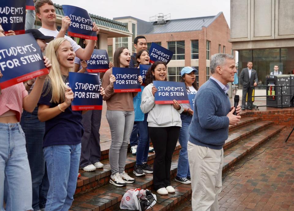 Students at the University of North Carolina Chapel Hill stand with 2024 governor candidate Josh Stein