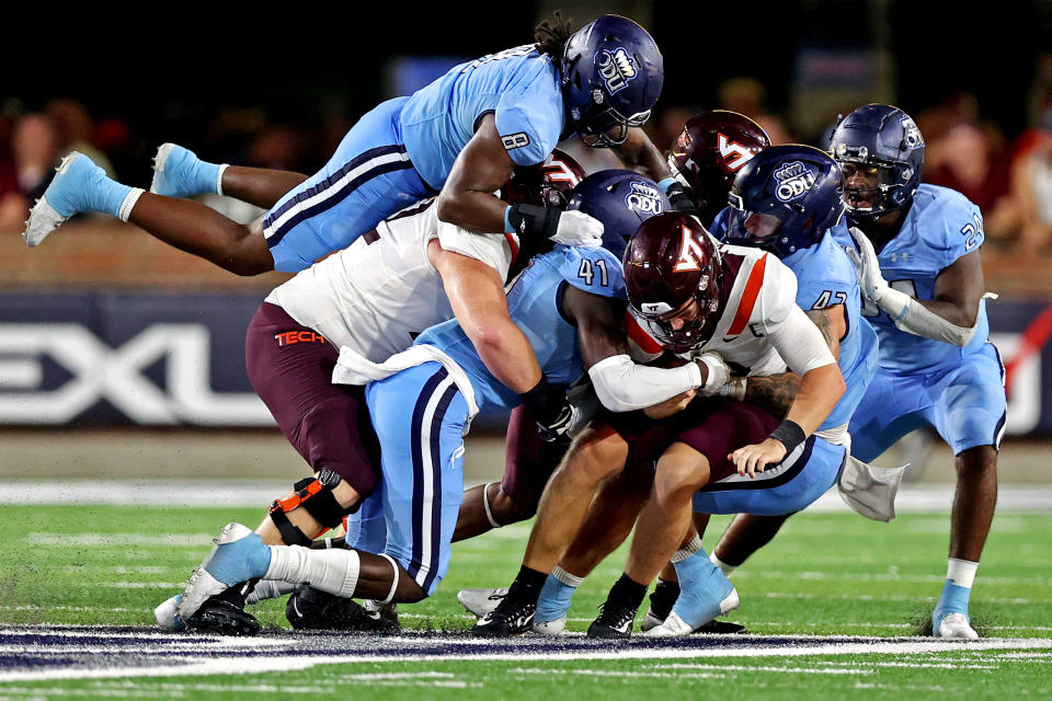 Sep 2, 2022; Norfolk, Virginia, USA;  Virginia Tech Hokies quarterback Grant Wells (6) is tackled Old Dominion Monarchs defensive end Kris Caine (41) during the fourth quarter at Kornblau Field at S.B. Ballard Stadium. Mandatory Credit: Peter Casey-USA TODAY Sports