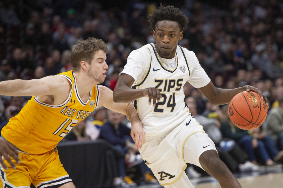 Akron's Ali Ali (24) is defended by Kent State's Mike Bekelja during the first half of an NCAA college basketball game in the championship of the Mid-American Conference tournament, Saturday, March 16, 2024, in Cleveland. (AP Photo/Phil Long)