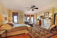 <p>The master suite is the perfect retreat thanks to its cozy decor and plenty of natural light. (Zillow) </p>