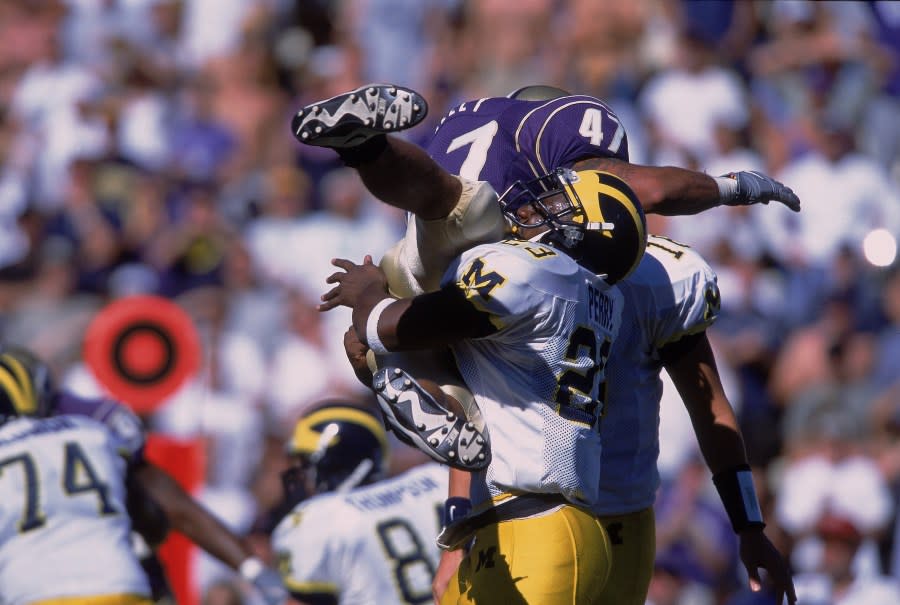 8 Sep 2001: Chris Perry #23 of the Michigan Wolverines catches Anthony Kelley #47 during the game against the Washington Huskies at the Husky Stadium in Seattle, Washington. The Huskies defeated the Wolverines 23-18.Mandatory Credit: Otto Greule /Allsport