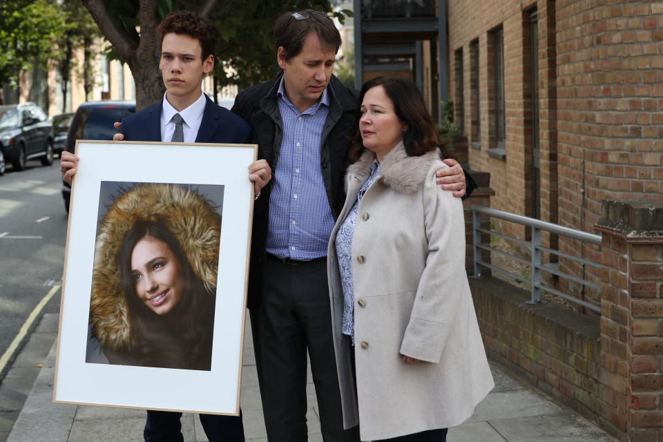 Nadim and Tanya Ednan-Laperouse, with their son Alex, prepare to speak to the media outside West London Coroners Court, Friday Sept. 28, 2018, following the inquest into the death of Natasha Ednan-Laperouse, 15, seen on poster, who died after suffering a fatal allergic reaction on a flight from London to Nice after eating a Pret A Manger sandwich at Heathrow Airport. Natasha's father, Nadim, said Friday he hoped the death of their daughter could serve as a watershed moment to make meaningful changes to allergy labelling on food packaging. (Jonathan Brady/PA via AP)