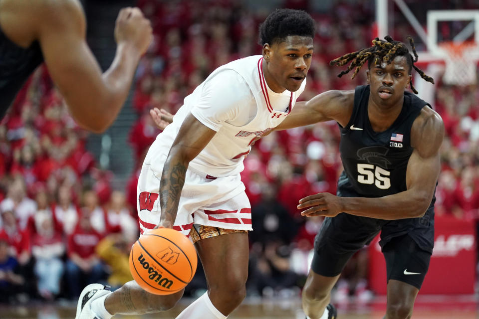 Jan 26, 2024; Madison, Wisconsin, USA; Wisconsin Badgers guard AJ Storr (2) dribbles the ball against Michigan State Spartans forward Coen Carr (55) during the second half at the Kohl Center. Mandatory Credit: Kayla Wolf-USA TODAY Sports