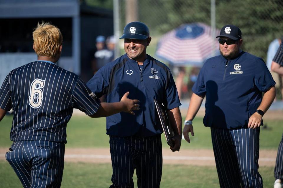 Central Catholic coach Danny Ayala and catcher Fernando Alaniz during the Northern California Regional Division III championship game awards ceremony at Central Catholic High School in Modesto, Calif., Saturday, June 3, 2023.