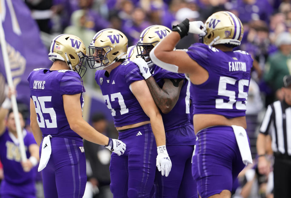 Washington tight end Jack Westover (37) reacts with tight end Josh Cuevas (85) after scoring a two-point conversion during the first half of an NCAA college football game against Oregon, Saturday, Oct. 14, 2023, in Seattle. (AP Photo/Lindsey Wasson)