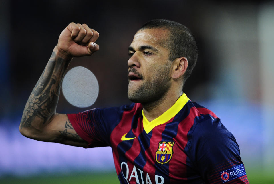 Barcelona's Daniel Alves celebrates at the end of their Champions League, round of 16, second leg, soccer match between FC Barcelona and Manchester City at the Camp Nou Stadium in Barcelona, Spain, Wednesday March 12, 2014. Alves scored the second goal in Barcelona's 2-1 win. (AP Photo/Manu Fernandez)