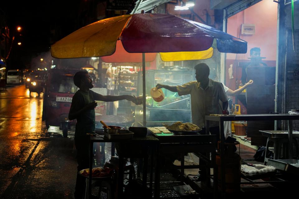 A street vendor sells food in Colombo, Sri Lanka on Dec. 28, 2022.