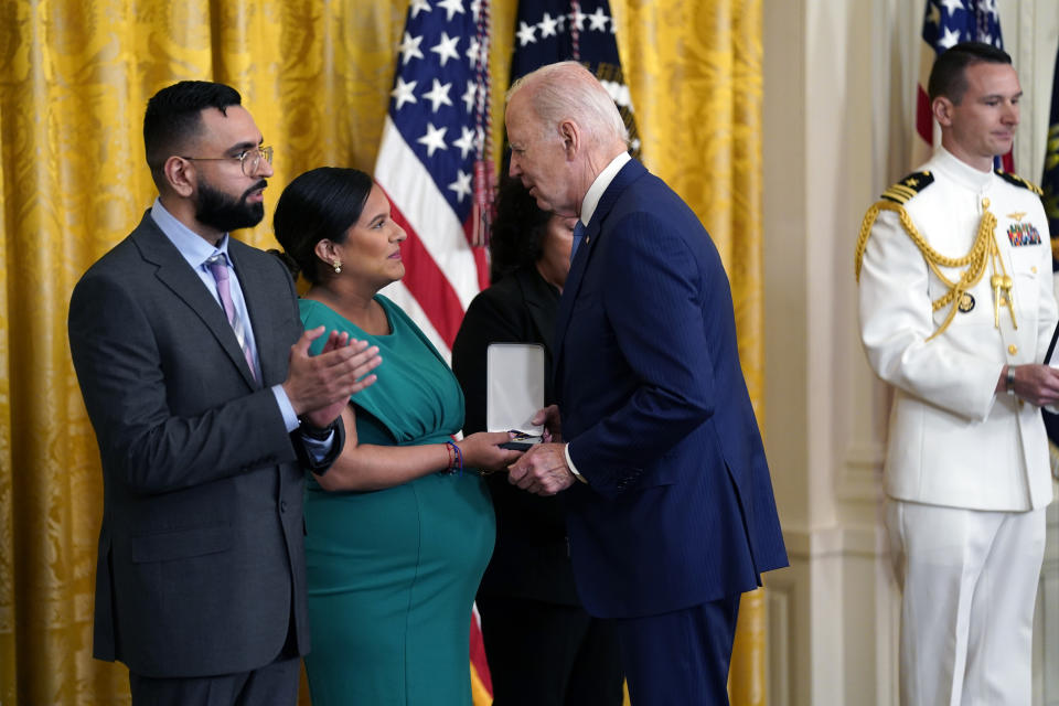President Joe Biden presents the Medal of Valor, the nation's highest honor for bravery by a public safety officer, to from right, Gabina Mora (Mother), accepting on behalf of Fallen Detective Wilbert Mora of the New York City Police Dept., Dominique Rivera (Wife), accepting on behalf of Fallen Detective Jason Rivera of the New York City Police Dept., and Detective Sumit Sulan of the New York City Police Dept, during an event in the East Room of the White House, Wednesday, May 17, 2023, in Washington. (AP Photo/Evan Vucci)