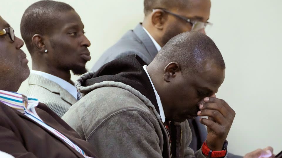 Eddie Terrell Parker, right, and his friend Michael Corey Jenkins react during Wednesday's sentencing hearing for six former Mississippi law enforcement officers who abused them for hours. - Rogelio V. Solis/AP
