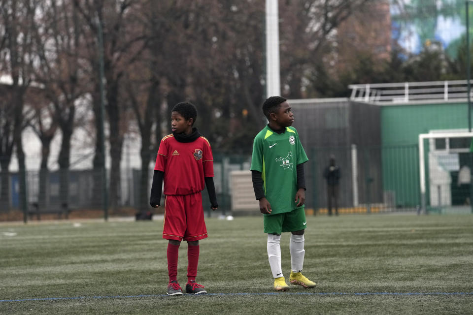 Player of the football club AS Bondy, where Kylian Mbappe played as a kid, Yacine Ngamatah, in green, stands on the pitch during a match on the Leo Lagrange stadium in Bondy, east of Paris, Saturday, Dec. 17, 2022. On the football fields where Kylian Mbappe hones the feints, dribbles and shots that all of France hopes to see in Sunday's World Cup final against Argentine, the next generation of French kids with big dreams is already hard at work to follow in the superstar's footsteps. (AP Photo/Thibault Camus)