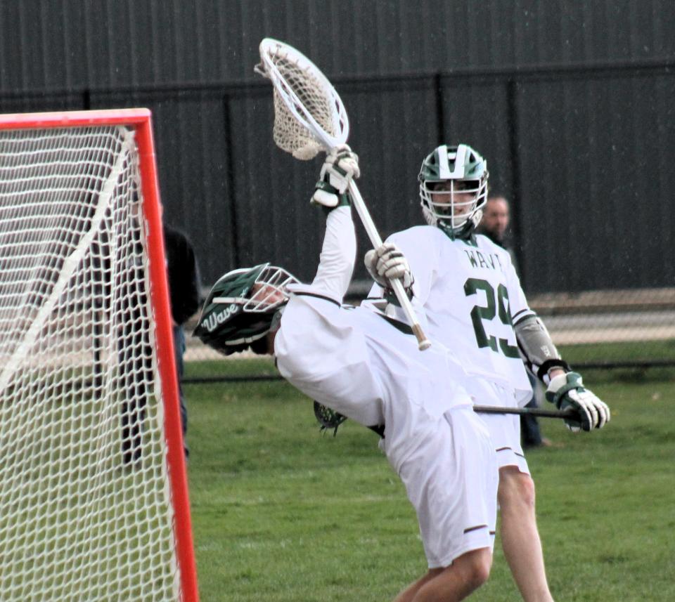 Dover High School boys lacrosse goalie Dom Chalifour makes one of his 22 saves during Wednesday's game against Bedford that also included his 700th career save that set a new state record.