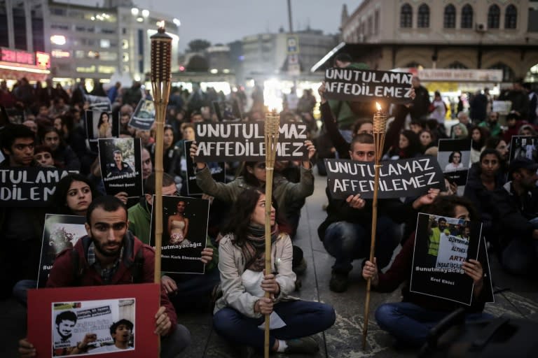 Demonstrators hold pictures of victims and signs reading 'unforgettable, unforgiven' on October 13, 2015 in Istanbul, during a rally against the deadly bomb attack in Ankara